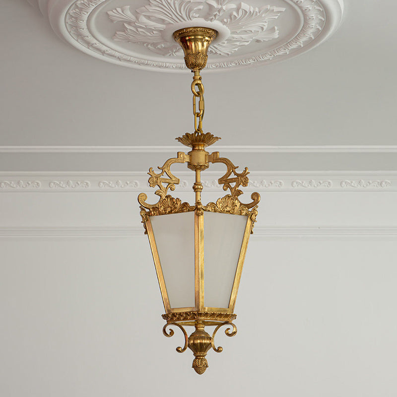 The lamp's hanging chain and ceiling mount in a matching brass finish.