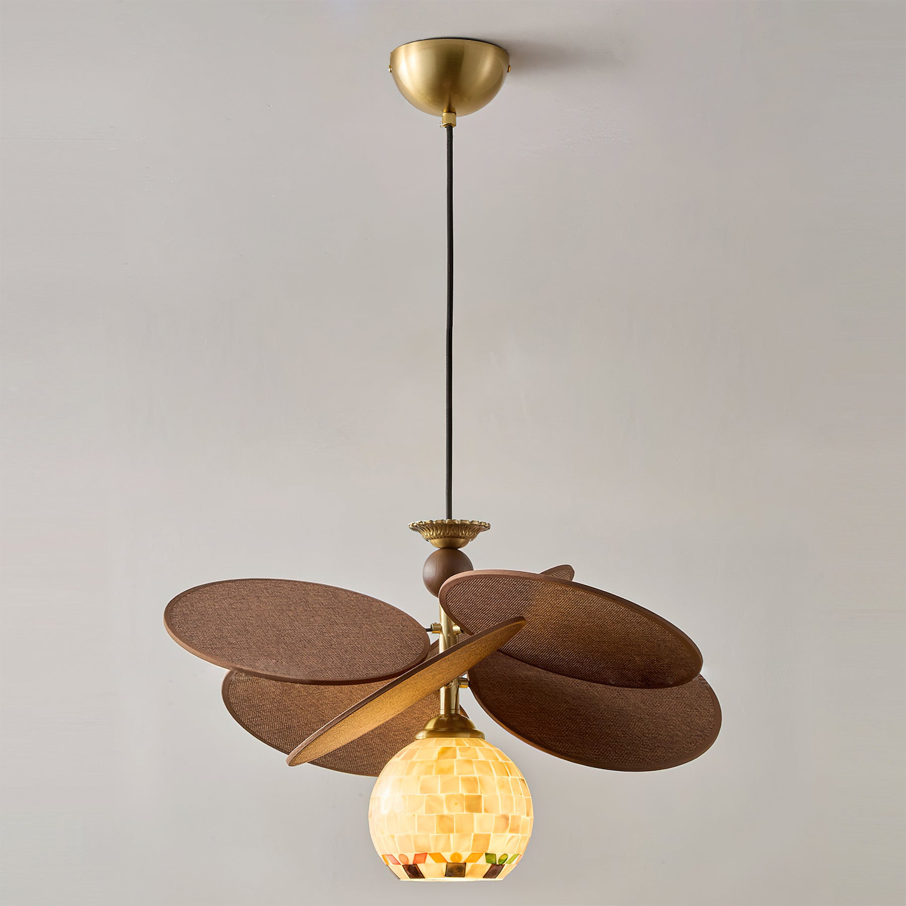 The interplay of light and shadow created by the raffia shade.