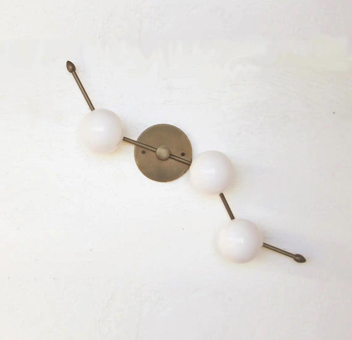 A lifestyle photo featuring the Zodiac Wall Lamp in a modern interior.