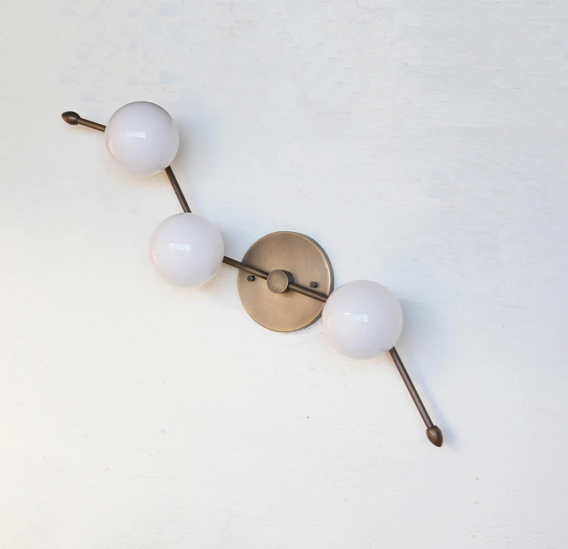The Zodiac Wall Lamp turned off, displaying its sculptural quality.