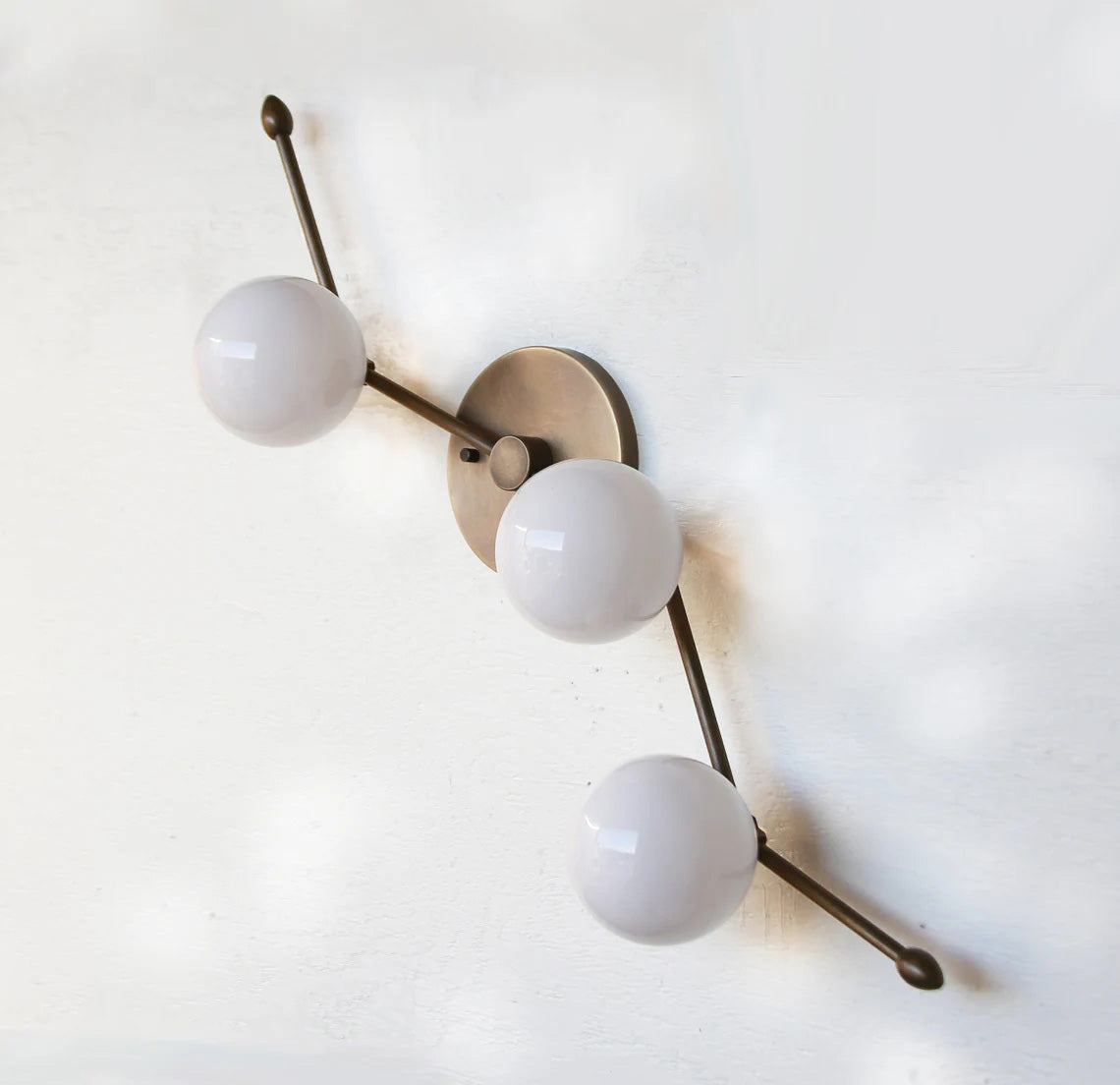 Another angle of the Zodiac Wall Lamp, showing its elegant form.