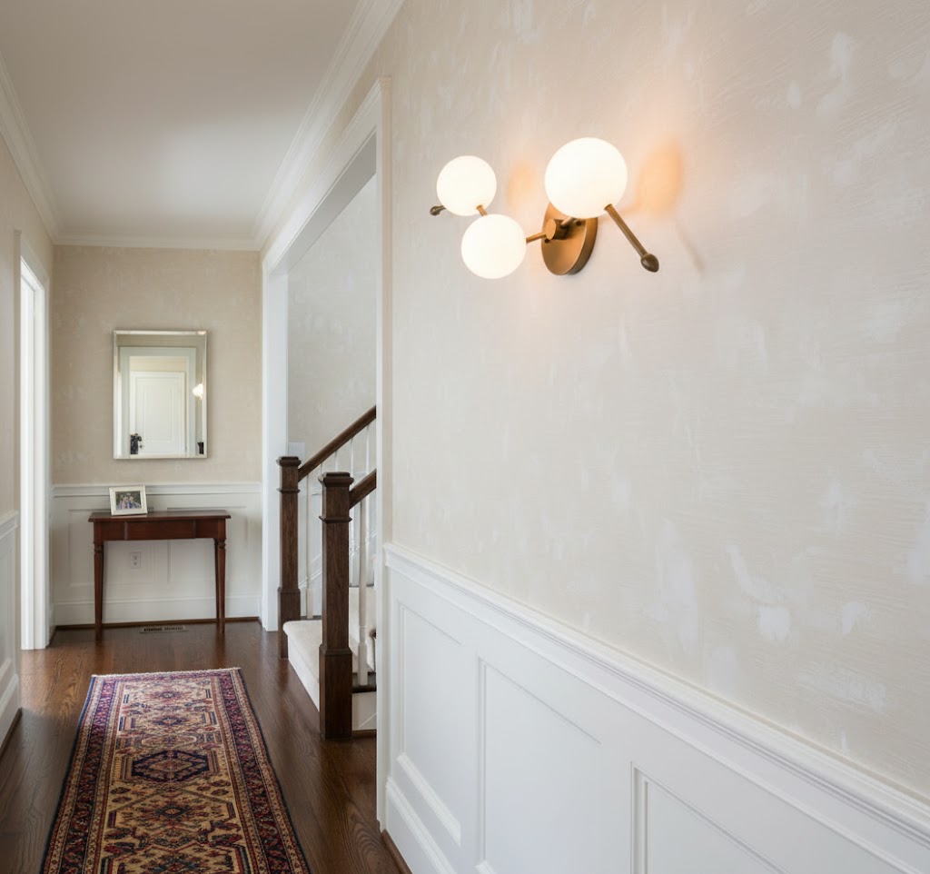 Angled view of the Zodiac Wall Lamp showcasing its linear brass body.
