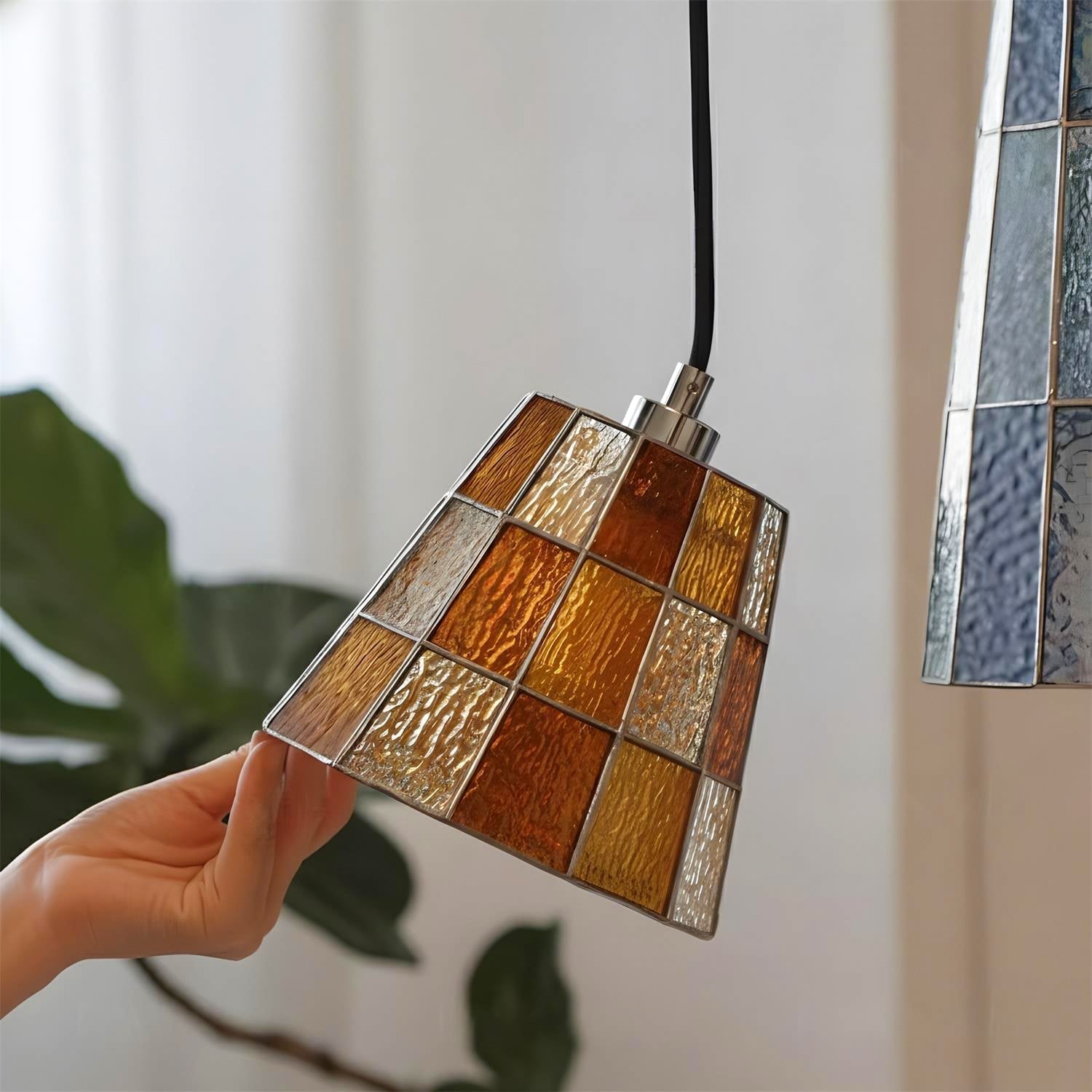 The Zola Pendant Lamp illuminated, casting a warm and inviting glow.