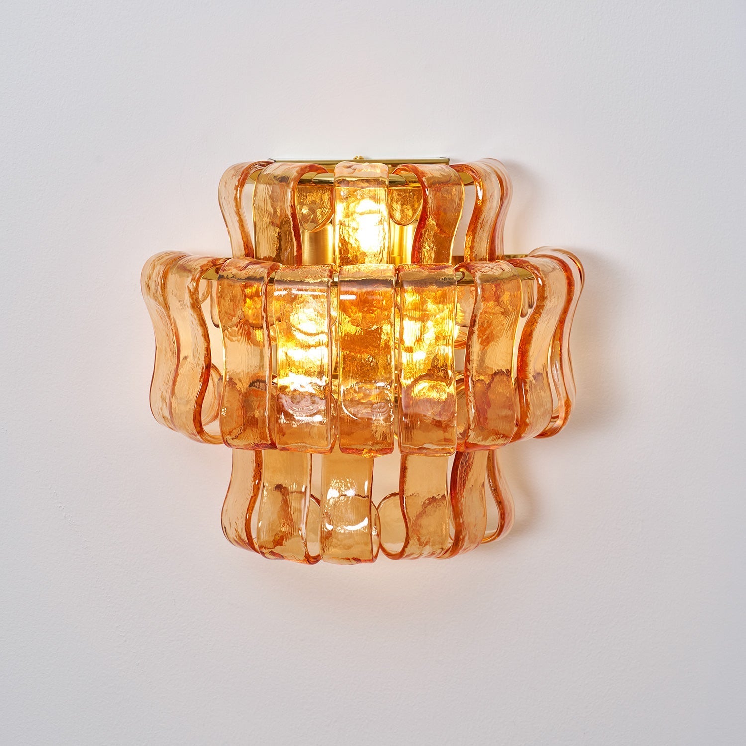 Angled shot of the clear glass Albano Wall Lamp.