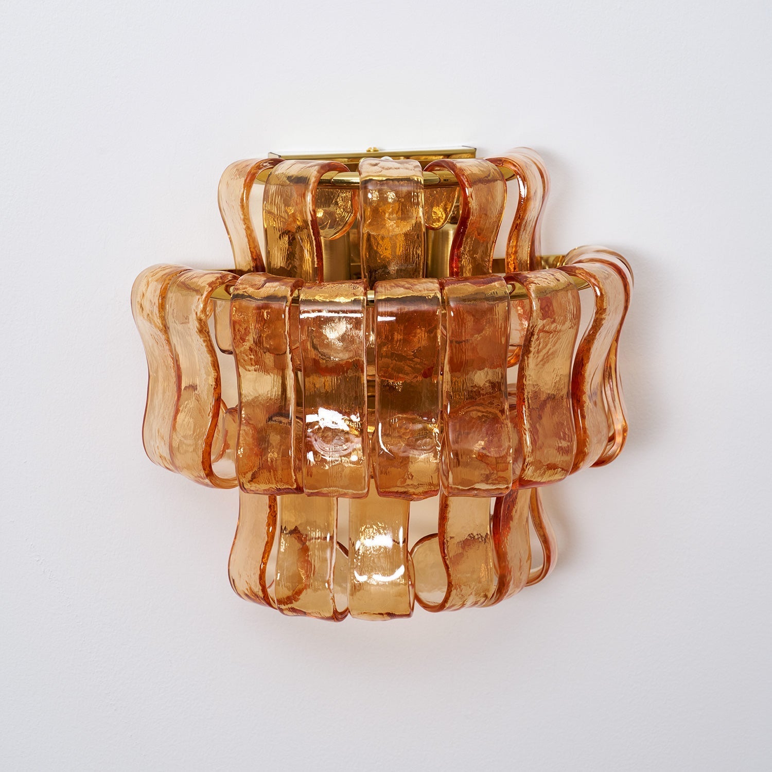 Angled shot of the amber glass Albano Wall Lamp.