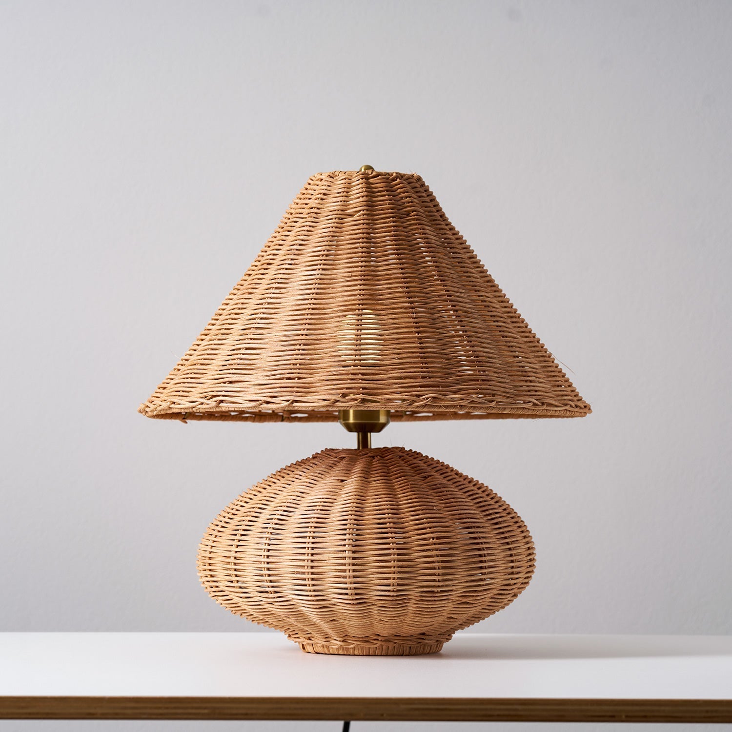 The soft, textured light pattern cast by the lamp on a nearby wall.