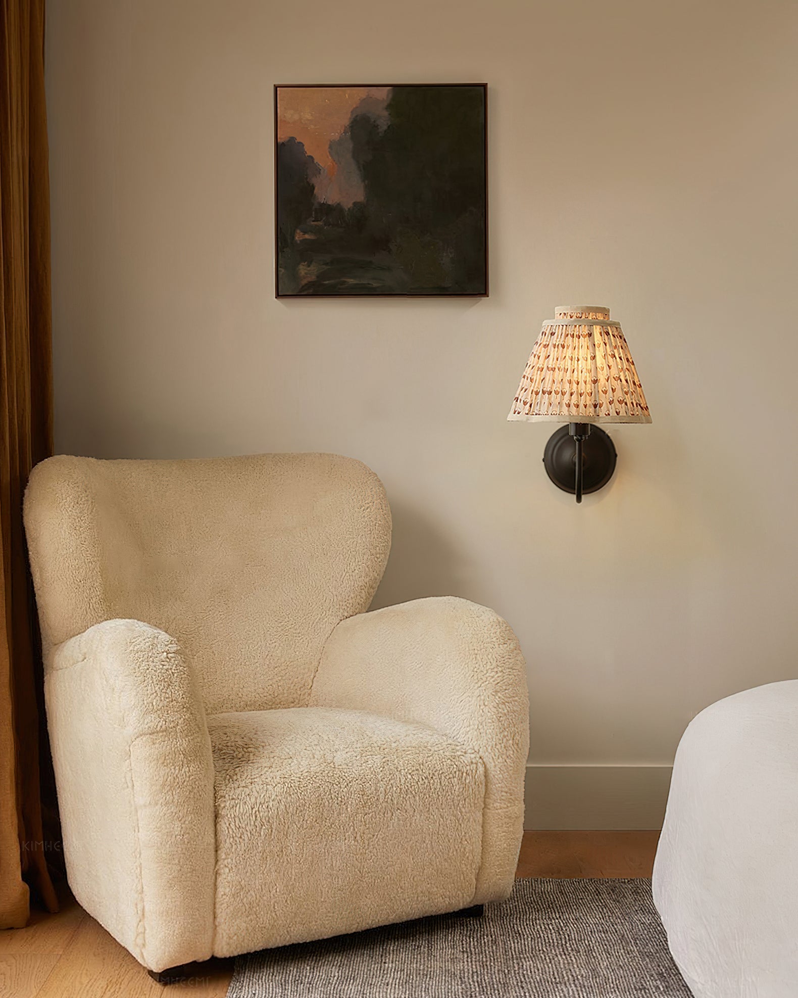 The Elbow Wall Light providing warm, ambient light in a reading nook.