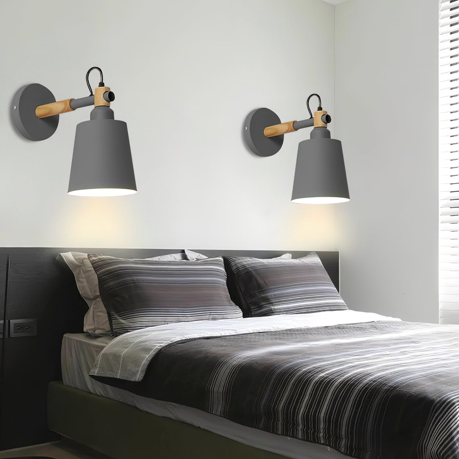 Copita Wall Lamp in black finish shown in a living room setting.