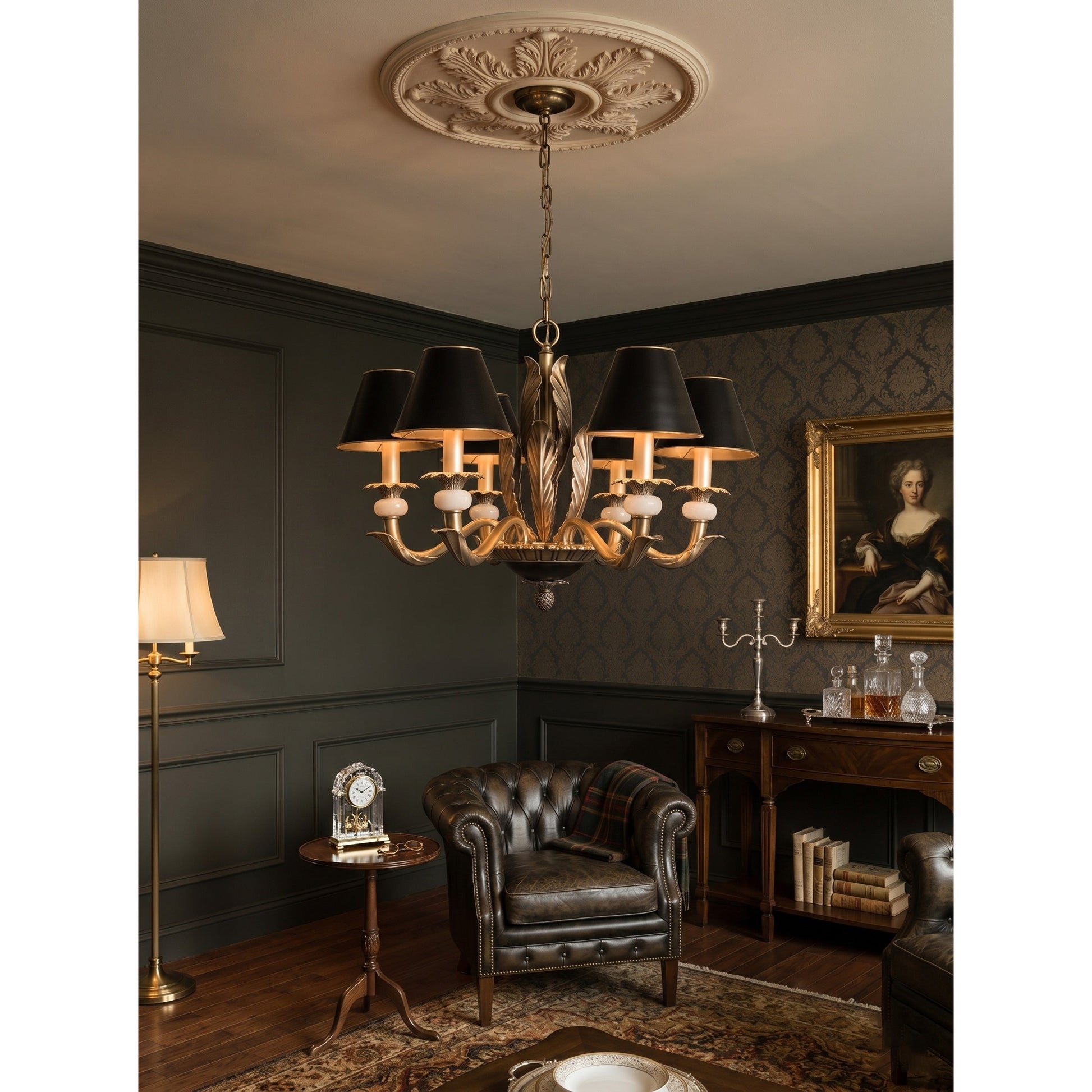The chandelier hanging in an entry foyer with a high ceiling.