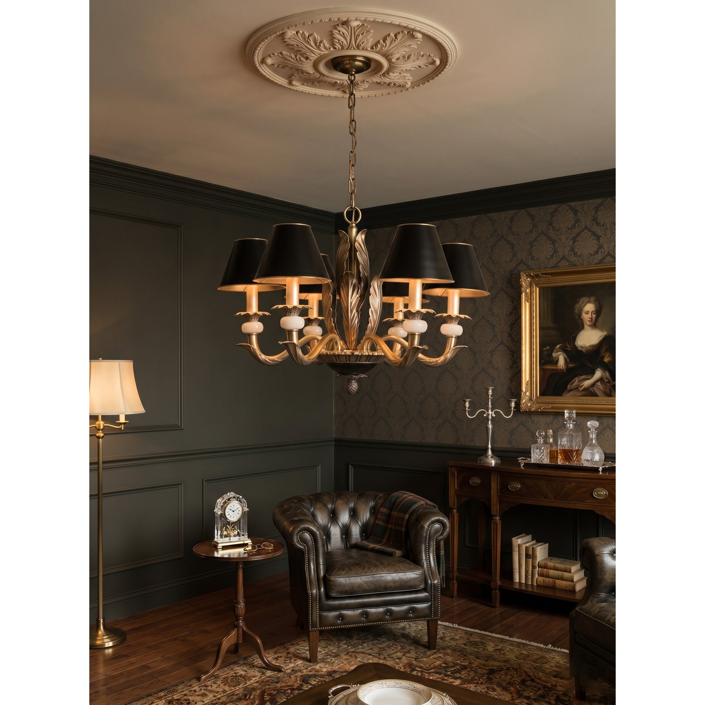 The chandelier hanging in an entry foyer with a high ceiling.