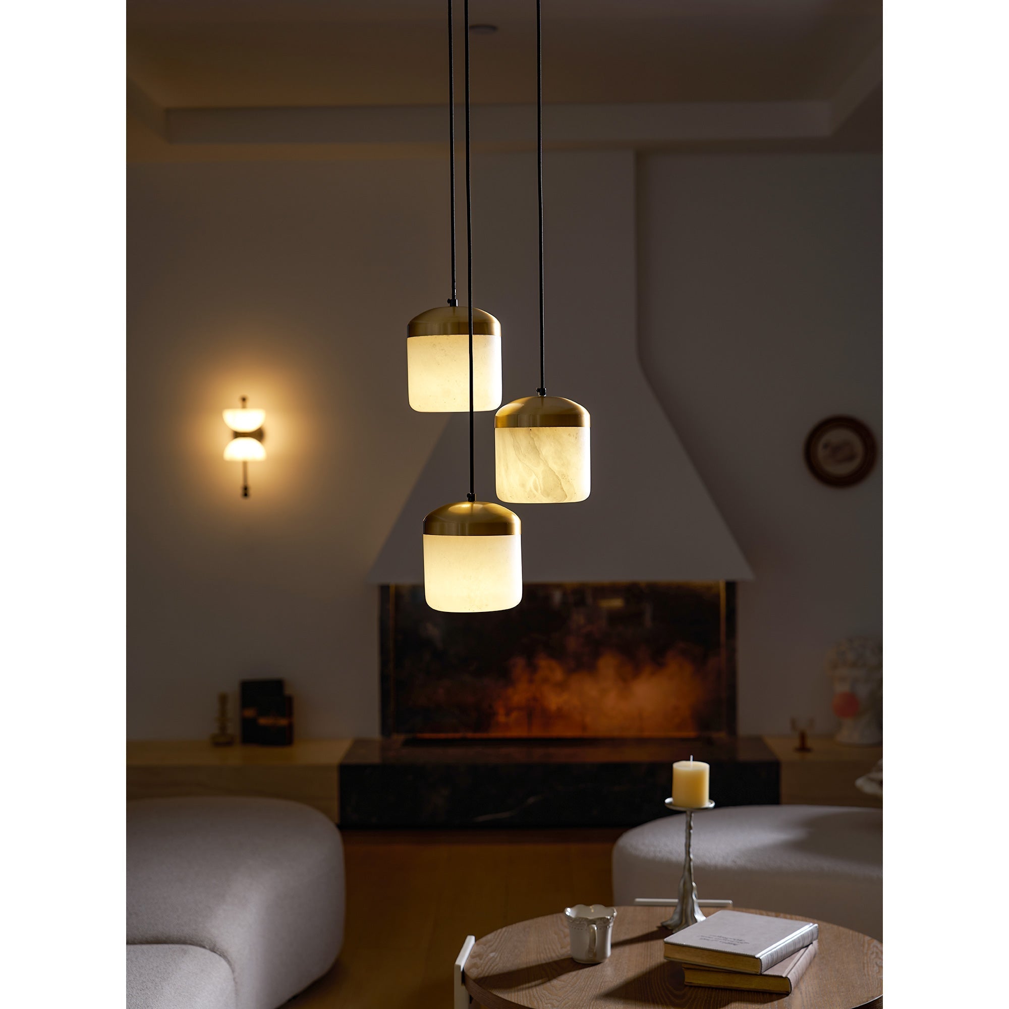 Multiple Asta pendant lamps hanging in a row over a counter.
