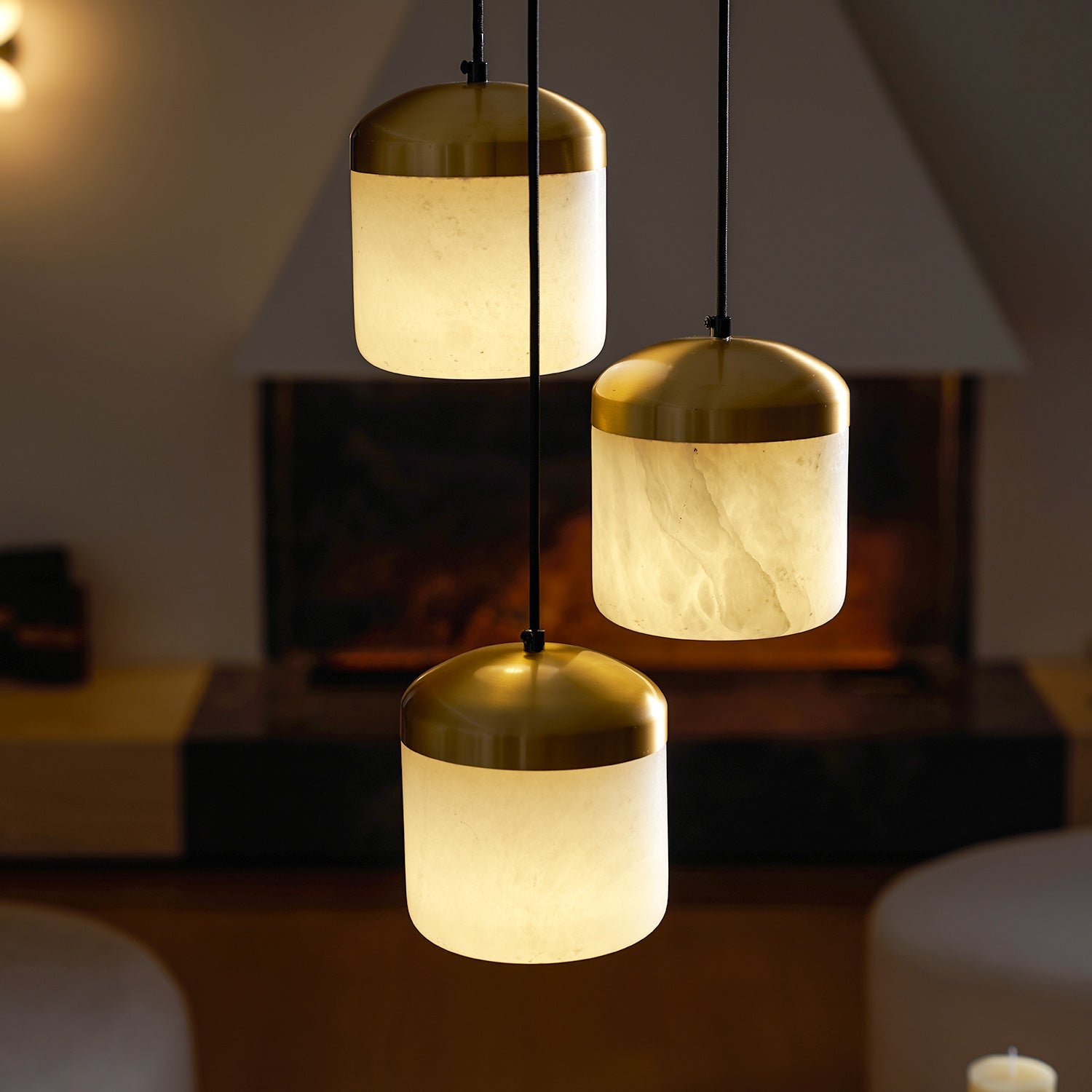 Asta pendant lamp illuminating a cozy bedroom corner.