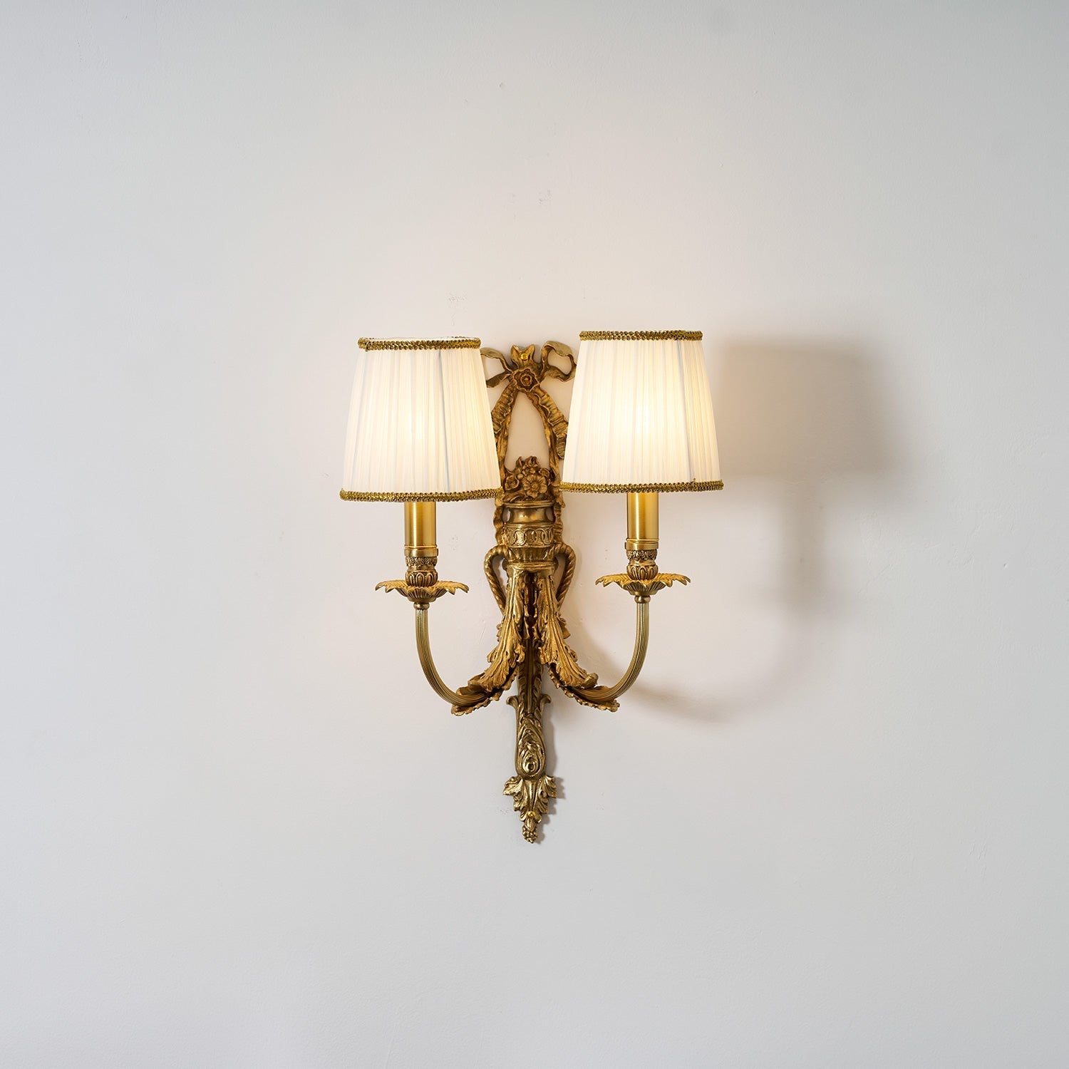 The soft diffusion of light through the white fabric shade.