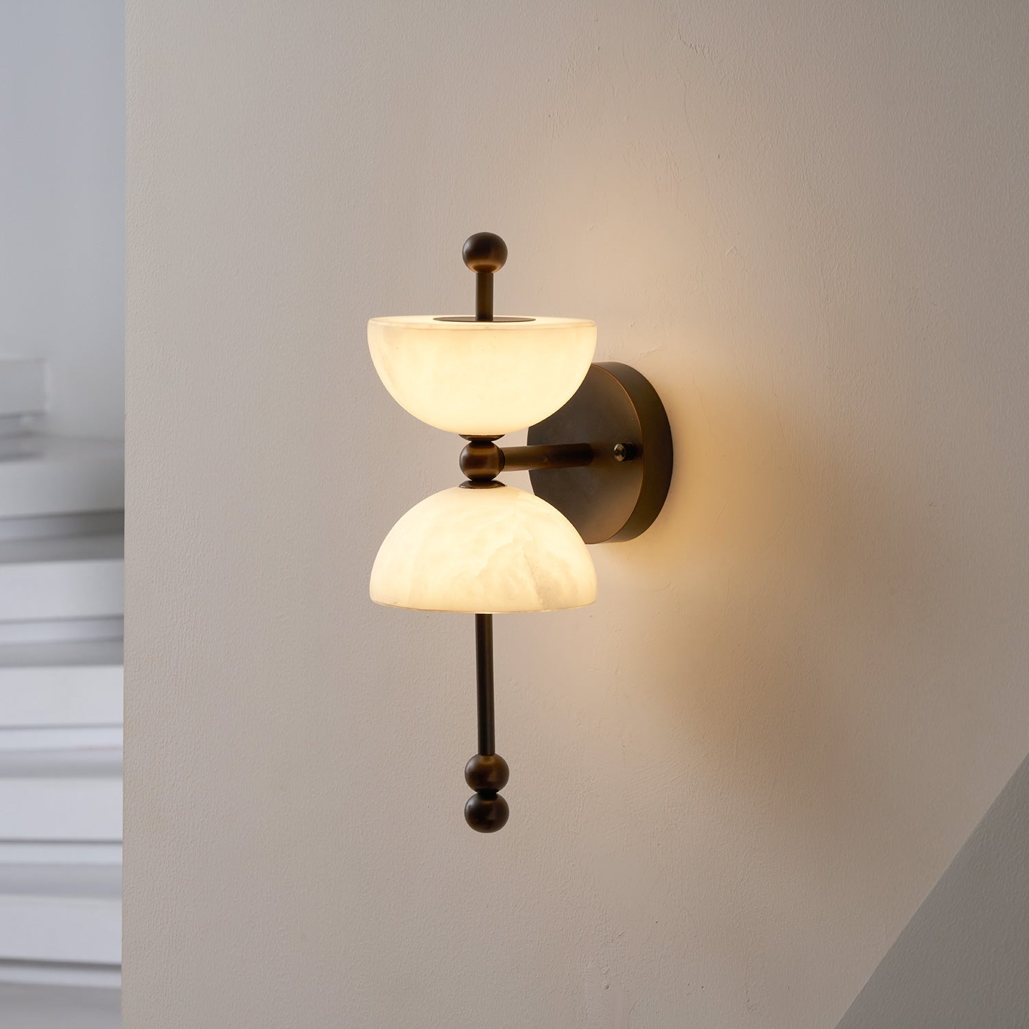 Lyra Wall Lamp installed in a contemporary living room setting.
