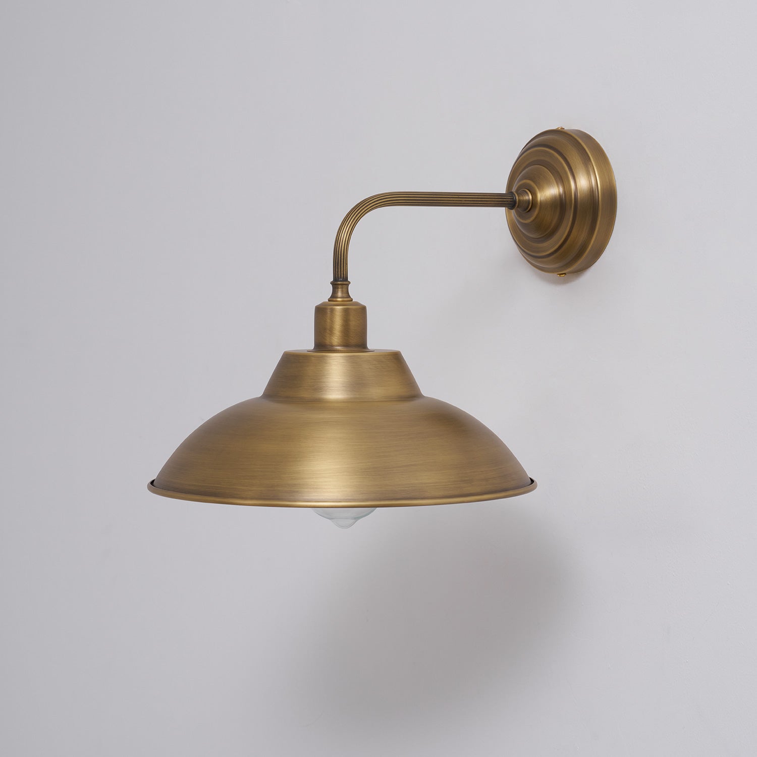 The elegant curvature of the Aldorno Wall Sconce's arm.