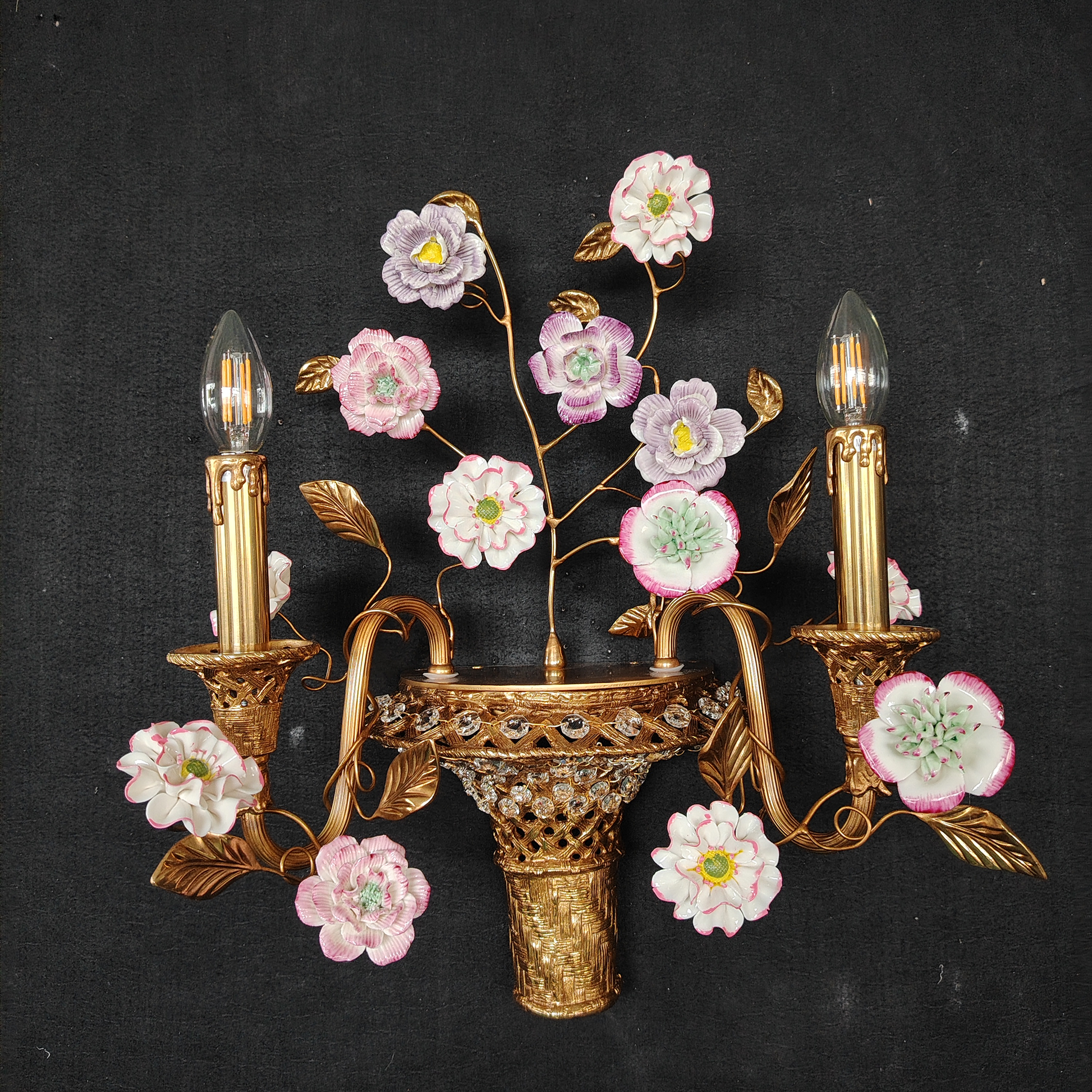 A pair of Tole Ceramic Flower Wall Lamps installed together.