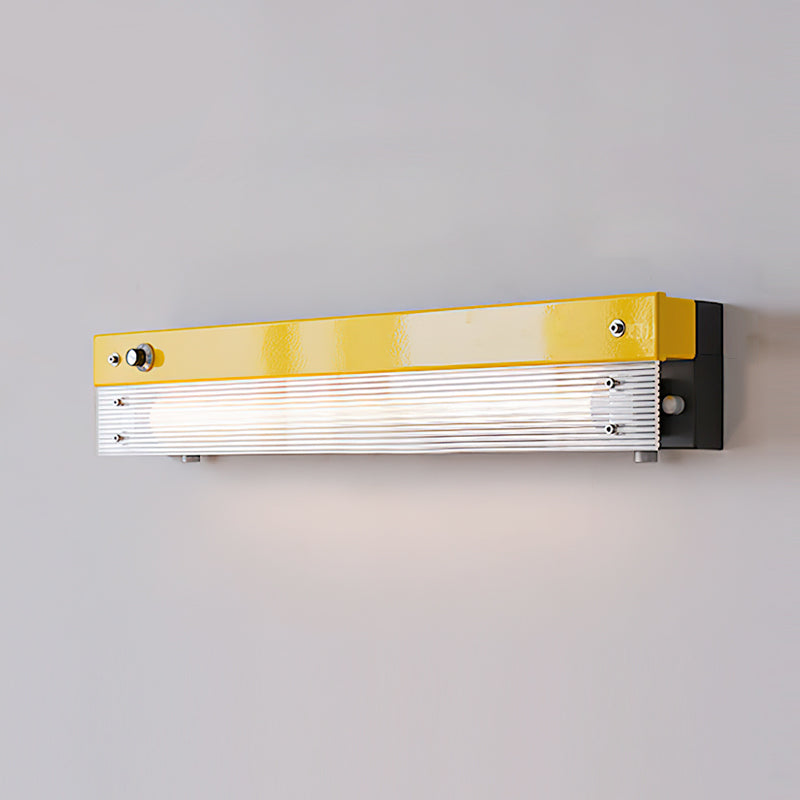 The yellow Totem Wall Lamp adding a pop of color to a minimalist room.